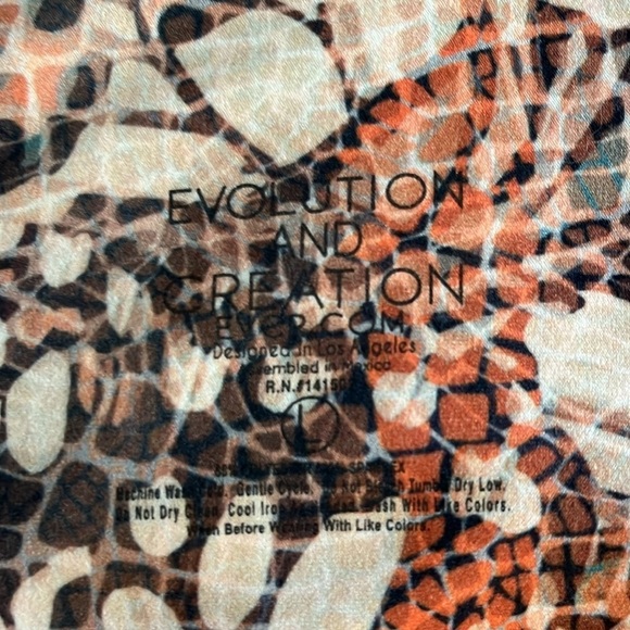 Evolution and Creation orange/cream/black patterned athletic pants. Size Large. - Picture 6 of 6